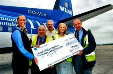 Pictured with thanks to Liverpool Airport:- Left to Right, Member of VLM Airlines Cabin Crew, Marshall Morris (Chairman FOLA), Graham Ward (Editor, FOLA Magazine), Christine Done, (Fundraising Manager, Alder Hey Hospital) and Eddie Quinn, (Treasurer FOLA).  