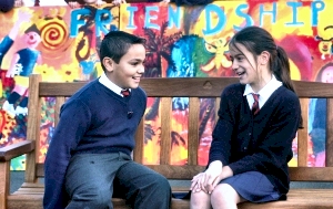 St Philips C of E Primary pupils Danny Jenner & Lauren Green, both of year six, show off their new friendship bench and colourful mural, funded with grant from the Community Foundation for Merseysides Childrens Voices Fund.