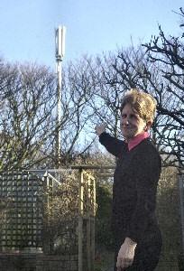 Mrs Cook shows us one of the 3 masts out side her houe.