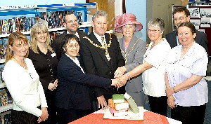 The Mayor of Warrington Cllr Ted Lafferty and the Mayoress, Pat Lafferty (centre) cut the cake with staff and library users at Culcheth