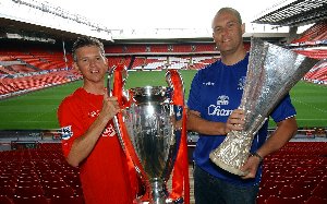 Looking forward to seeing their teams progress in Europe, life long ‘Reds’ supporter Robin Tudor, Liverpool John Lennon Airport’s Corporate Affairs Manager with the European Cup and ‘Blues’ fan Phil Webster, the Airport’s Engineering Manager, with the UEFA Cup.
