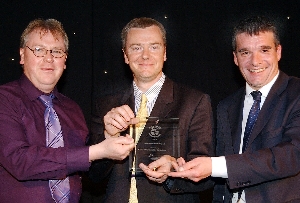 Paul McQuade and Ian Sanderson of St Helens Shopmobility collect their Best Inclusion Project Award from Community Foundation Executive Director Dave Roberts.