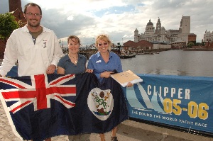 Left to right: Ewan Hind, Carrie Smith and Carol White exchange gifts against the beautiful backdrop of the Liverpool skyline. 