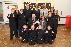 The Poulton Lancelyn Primary School trampolining squad, with (left to right, back row) Eileen Ashurst, deputy headteacher, Dan Arnold, PE coordinator, Helen Pirie, Poulton Manor sales consultant, Elaine Mounsey, Redrow North West area sales manager and Wendy Williamson, coach. Centre: Paul Crombie, Poulton Manor construction manager and headteacher, Beverley Greathead.