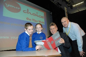 Abbie Rawlinson and Sean Smith from St Teresa's Catholic Junior School with event co-ordinator Billy Bradshaw (far right) and Neil Scales, Chief Executive and Director General of Merseytravel.