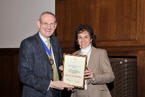 Nikki Barker is pictured on the right of the photo receiving the award from IMechE President John Baxter