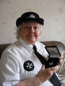 Picture. Ann Lloyd with the medal she was awarded.