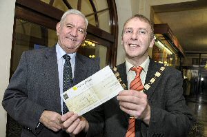 Councillor Mark Dowd (left) presents the money to Councillor Paul Tweed, Mayor of Sefton, at Bootle Town Hall. 