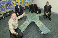 (left to right): Colin Powell, Cllr Mark Dowd, Phil Redmond and Neil Scales with the All Together Now bench in Queens Square Travel Centre.