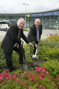 Pictured (l � r): Councillor Peter Millea and Councillor Alan Dean, Members of Merseytravel�s Integrated Transport Authority, plant the oak sapling at Liverpool South Parkway.