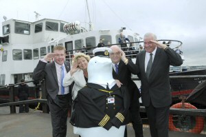 Cllr Mark Dowd and Cllr Chris Blakeley are joined by Cllr Warren Bradley, Sally-Ann Wilkinson and Perry the Penguin on board the Royal Iris to launch Merseytravel’s partnership in Go Penguins.