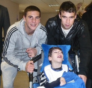 Dan Gosling (left) and Seamus Coleman bring a smile to the face of Patrick Bishop, 9.