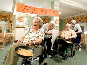 Pancake Racers, Residents Doreen Stephenson and Ted Marks are joined by cooks Majorie Bell and Paul Lowe