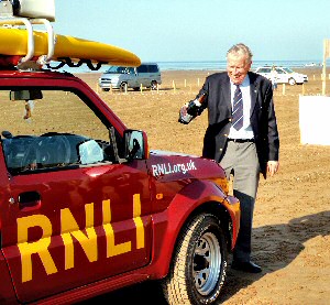 CSMA/Frizzell Charity Coordinator, Tony Richardson toasts the RNLI's new lifeguard patrol vehicle at Ainsdale beach (Credit RNLI)
