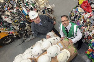 Brian Handcock (left) and Peter Ball (right) take a closer look at the hard hats to be recycled.