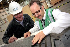 Peter Ball (left) shows Brian Handcock (right) how the sustainable EcoSheet boards are manufactured.