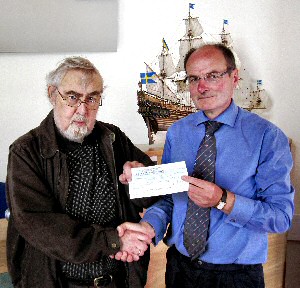 John Wilson (right) hands out grant cheque to beneficiary