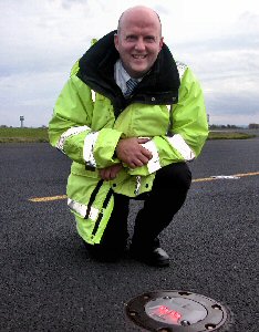 Andrew Dutton, out on the aircraft taxilane at JLA with one of the new low energy lights.