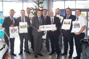 (centre left) Chris Normington from the JDRF receiving Polar Fords 6,000 donation from John Leeman (centre right) and the Polar Ford management with their calendar. 