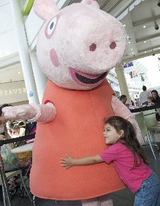 Abigail Pidugu, three, from Birkenhead gives Peppa a hug.