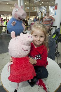 Freya Owen, 4, from Birkenhead, brought her own Peppa Pig to meet George who is pictured in the background.