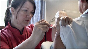 Suzanne Marshall, matron on infectious diseases unit at the Royal vaccinating a colleague.