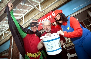 Neil Wilson is pictured (centre) with superhero colleagues Mark Edge and Sophie Houghton.