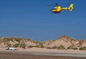 The photograph shows the Air Ambulance arriving at the scene. Photo credit: Patrick Trollope.