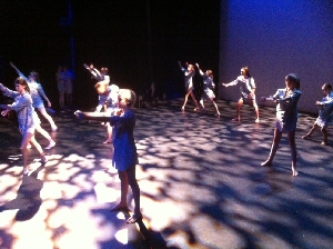 Dance students in full flow on stage. 