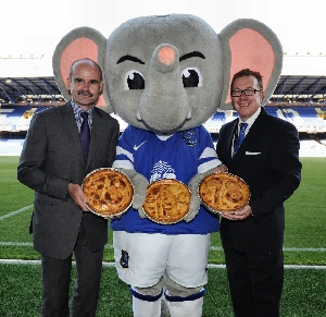 Brian Ashworth, from Clayton Park Bakery (L) and Ian Simpson, General Manager of Sodexo at Everton (R) with Changy, the Everton mascot.