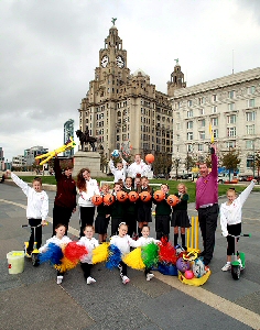 Great Crosby Catholic Primary School pupils (Phoebe Biddlestone, Alfie Colligan, Jake Roberts, Isabel Mitchell, Adam Henders and Amy Withell) celebrating the donation from Sainsbury's Active Kids with Liverpools rising star athlete Sophia Brennan, Gymnasts from Liverpool Gymnastics and Sainsburys colleagues.