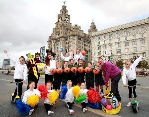 Great Crosby Catholic Primary School pupils (Phoebe Biddlestone, Alfie Colligan, Jake Roberts, Isabel Mitchell, Adam Henders and Amy Withell) celebrating the donation from Sainsbury's Active Kids with Liverpools rising star athlete Sophia Brennan, Gymnasts from Liverpool Gymnastics and Sainsburys colleagues.