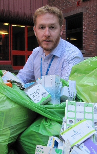 Picture shows Steve Simpson, Clinical Pharmacy Manager, with examples of medicines thrown away due to duplicate prescriptions