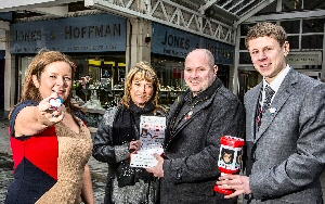 Denise and Stuart Fergus with the James Bulger Memorial Trust collection box and badges, with Sharon Jones- Hoffman and her son Ryan, at the family jewellery shop in Church Square Shopping Centre, St Helens, Meseyside.