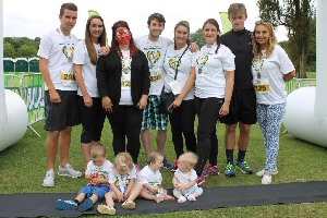 Sarah and Craig Holmes (3rd and 4th from the left) with family, friends and children