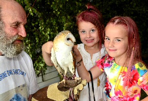 Tiffany Harbour and Jade Kelly, both six, from Birkenhead. They are pictured with Terry Gurr of the Moonshine Owl Sanctuary and a 13 year old Barn Owl.