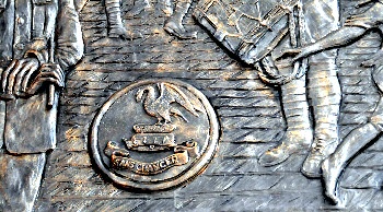 A close up of one of the Memorial Frieze pannels with the Pals badge on it.