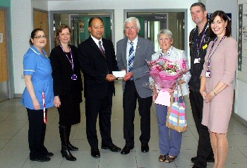 Picture shows Graham and Marilyn Robinson presenting a donation to Mr Aung Oo, Consultant Cardiac Surgeon, with Jane Tomkinson, Chief Executive, and other members of the aortic surgery team