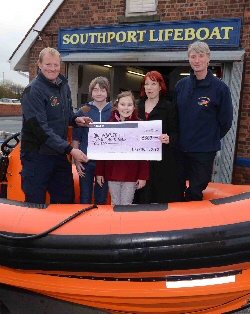 From left Keith Porter - Senior Coxswain, Centre, Nicola Hughes with children Kane,14, and Emily, nine and far right is Phil Wade, lifeboat lotto canvasser and Support Crew.