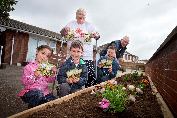 Charity trustee Linda Evers and husband Frank Evers "Sow the seeds of hope" alongside their grandchildren whilst on holiday in Burnham-on-Sea