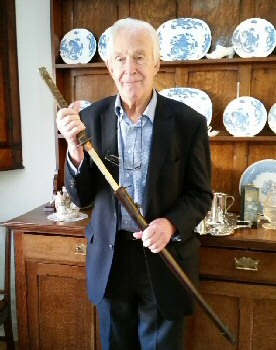 Photo shows COFEPOW member Patrick Toosey with a Samurai sword brought back from the Far East by his father.