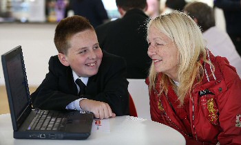 Photograph caption one: Michael Dobie, 13, is pictured with Eileen Finnegan during Get Online Week at Joseph Williams Mews.