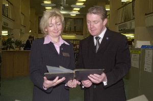 Local Councilor Warren Bradley and Joyce Little looking at over past times.