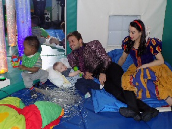 James Hill and Georgia Austin, stars of Snow White, with the children, parents and staff at Zos Place Baby Hospice in West Derby.