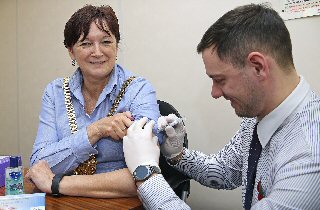 The Lord Mayor being given a flu jab by Kevin Murray, a pharmacist at Lloyds Chemist