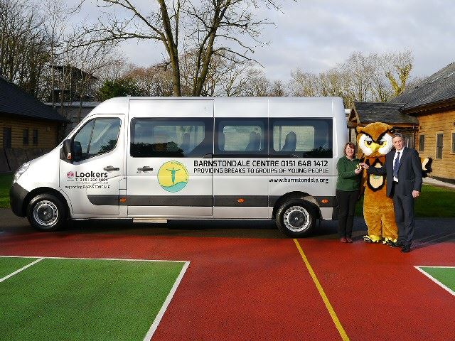 Heidi Hughes, Business Development Director at Barnstondale with Barnie Owl, accepting the keys to the new minibus from Martin Benbow, General Manager at Lookers Vauxhall Birkenhead.