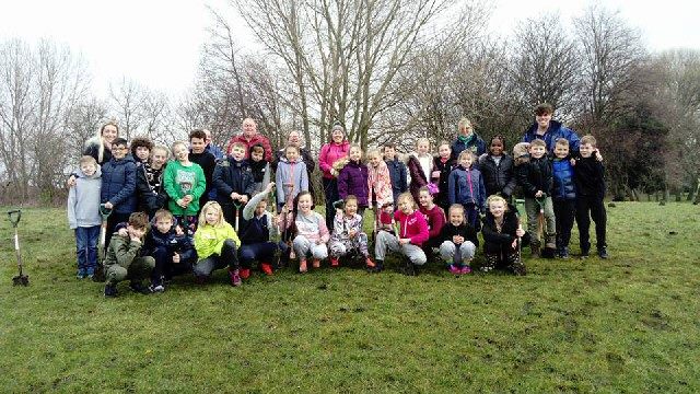 Photo shows children from Northcote School with teachers, Friends of Walton Hall Park volunteers and staff from Mersey Forest.