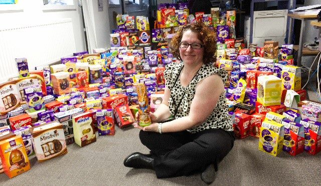 BEST NEST: Liverpool City Council Charity Champion Lisa Flynn surrounded by some of the hundreds of chocolate Easter Eggs collected by council staff. 