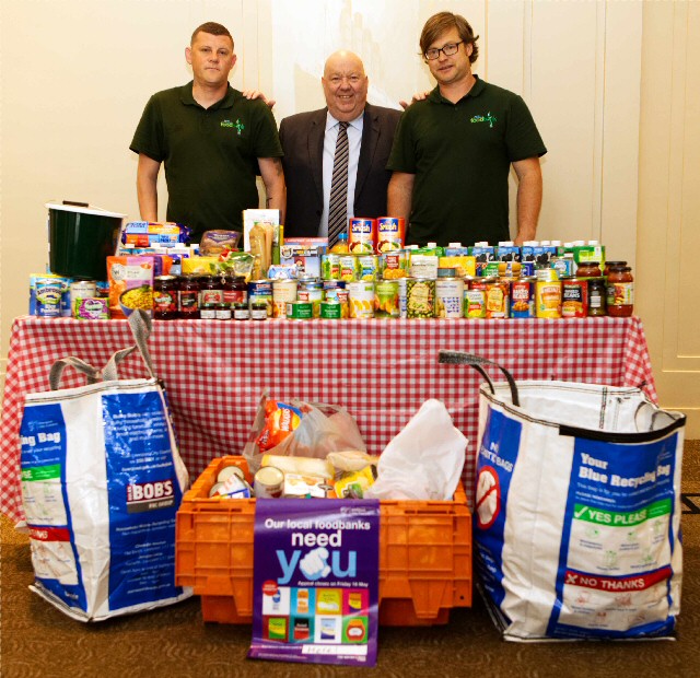 Mayor of Liverpool Joe Anderson shows just part of the city council food collection Simon Huthwaite and foodbank volunteer Stephen Middleton. 