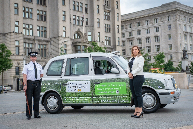  Inspector Andy Greer from Merseyside Police with Jenny Davies from Liverpool City Councils Alcohol and Tobacco Unit and one of the branded taxis promoting Drink Less Enjoy More during the World Cup